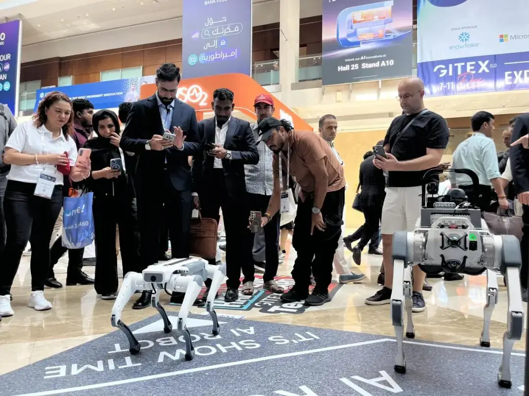 Visitors at GITEX GLOBAL 2025 interacting with DEEP Robotics Lite3 quadruped robot, showcasing advanced mobility and AI-powered robotic technology.