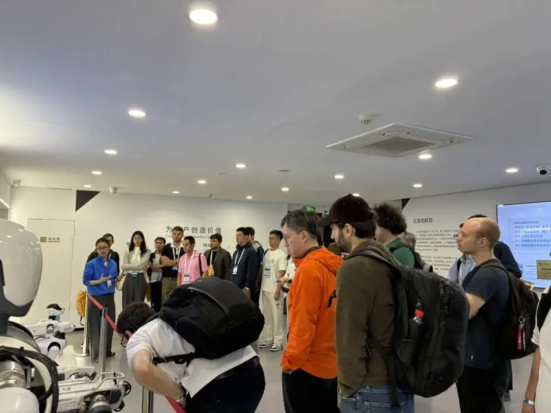 DEEP Robotics booth at IROS 2025 showcasing advanced quadruped robots, with visitors exploring the latest robotic innovations and autonomous walking systems.