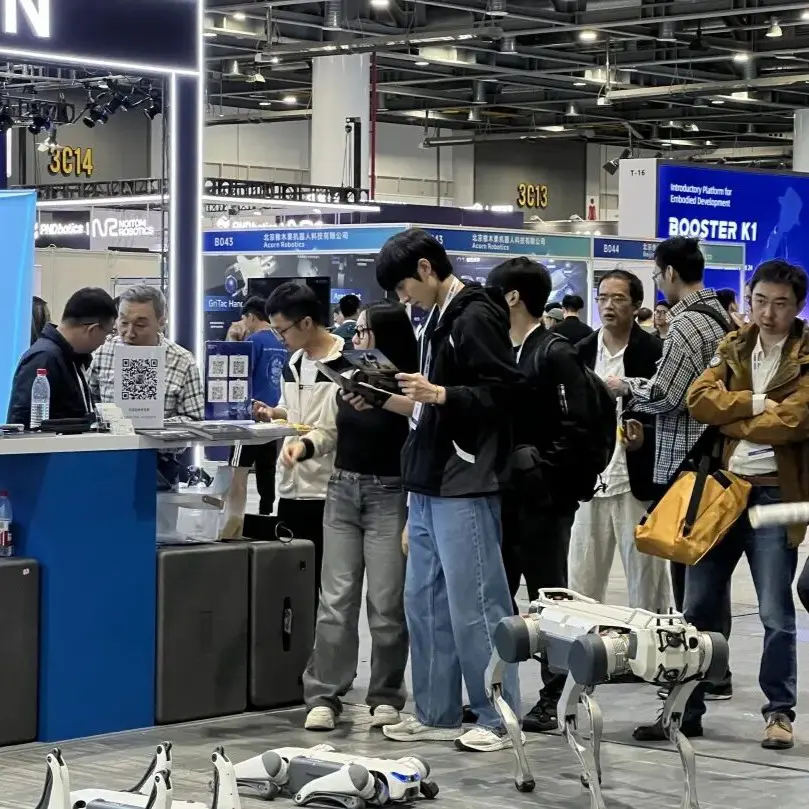 DEEP Robotics booth at IROS 2025 showcasing advanced quadruped robots, with visitors exploring the latest robotic innovations and autonomous walking systems.