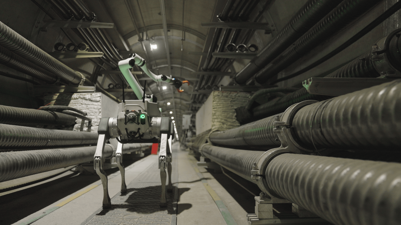 DEEP Robotics X30 Pro quadruped robot equipped with a robotic arm performing intelligent inspection and maintenance at a power station.